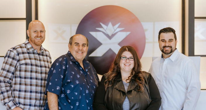 About BoomX massachusetts dispensary - posed photo of Cardillo family, owners of BoomX, at the dispesnary